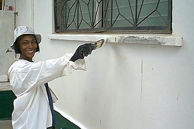 Sandy paints the window ledge she's repaired