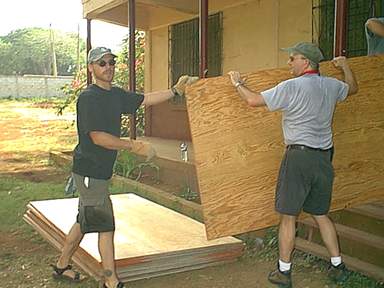 Brian and Jim C. move plywood