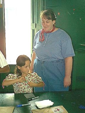 Tammy helps a child